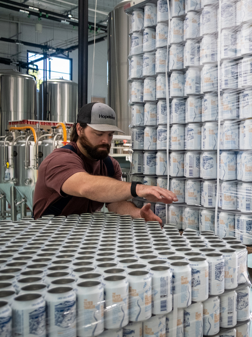 Siren Rock Brewmaster Hayes Cooper canning beer at Siren Rock Brewing Company